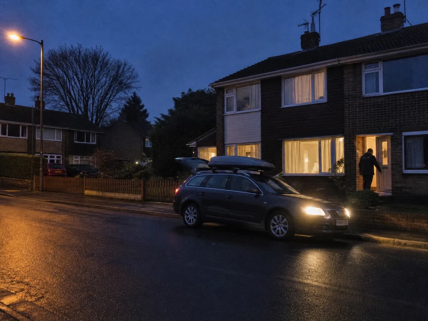 Estate car waiting outside a house before dawn