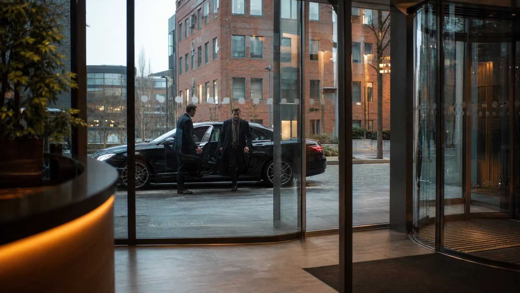 Business traveller arriving outside an office lobby